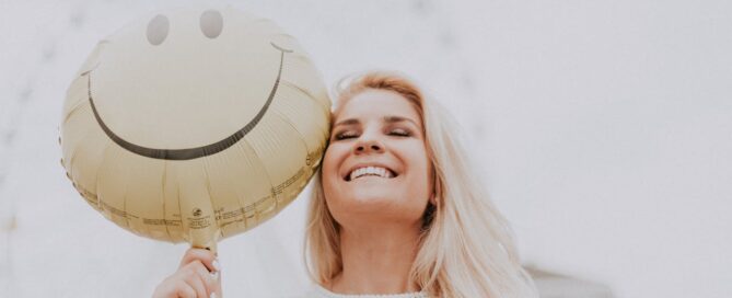Photo by Julia Avamotive: https://www.pexels.com/photo/woman-holding-a-smiley-balloon-1236678/ -- happy customer; case study
