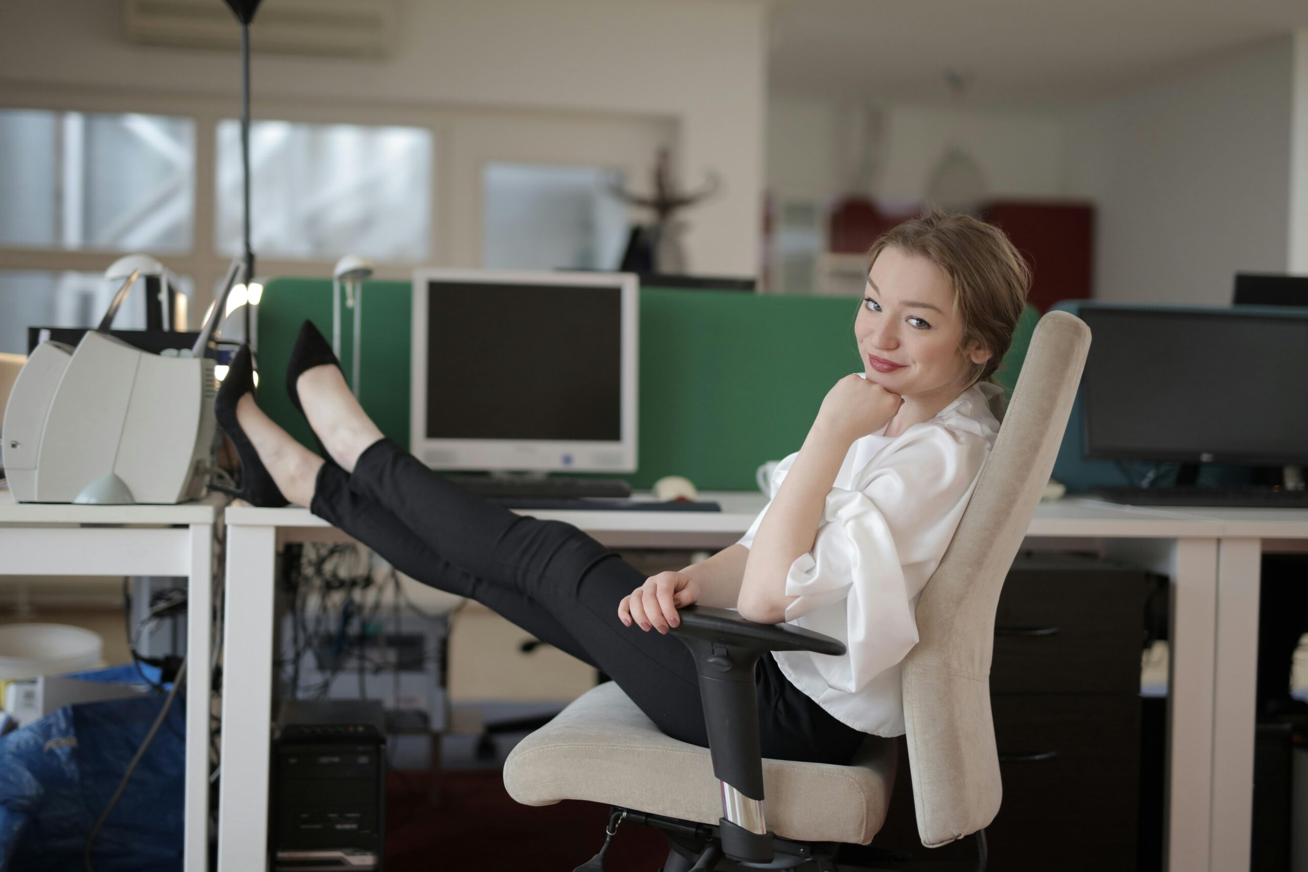 Photo by Andrea Piacquadio: https://www.pexels.com/photo/smiling-elegant-female-employee-with-feet-on-table-3791533/